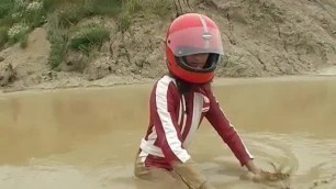 Girl in Motorcycle Leathers and Helmet getting Wet