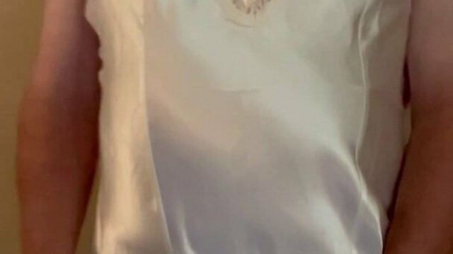 Crossdresser wearing white satin chemise and stockings
